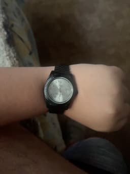 Rolex Datejust-style black-coated wristwatch with silver dial and Jubilee-style bracelet - AI says Fake