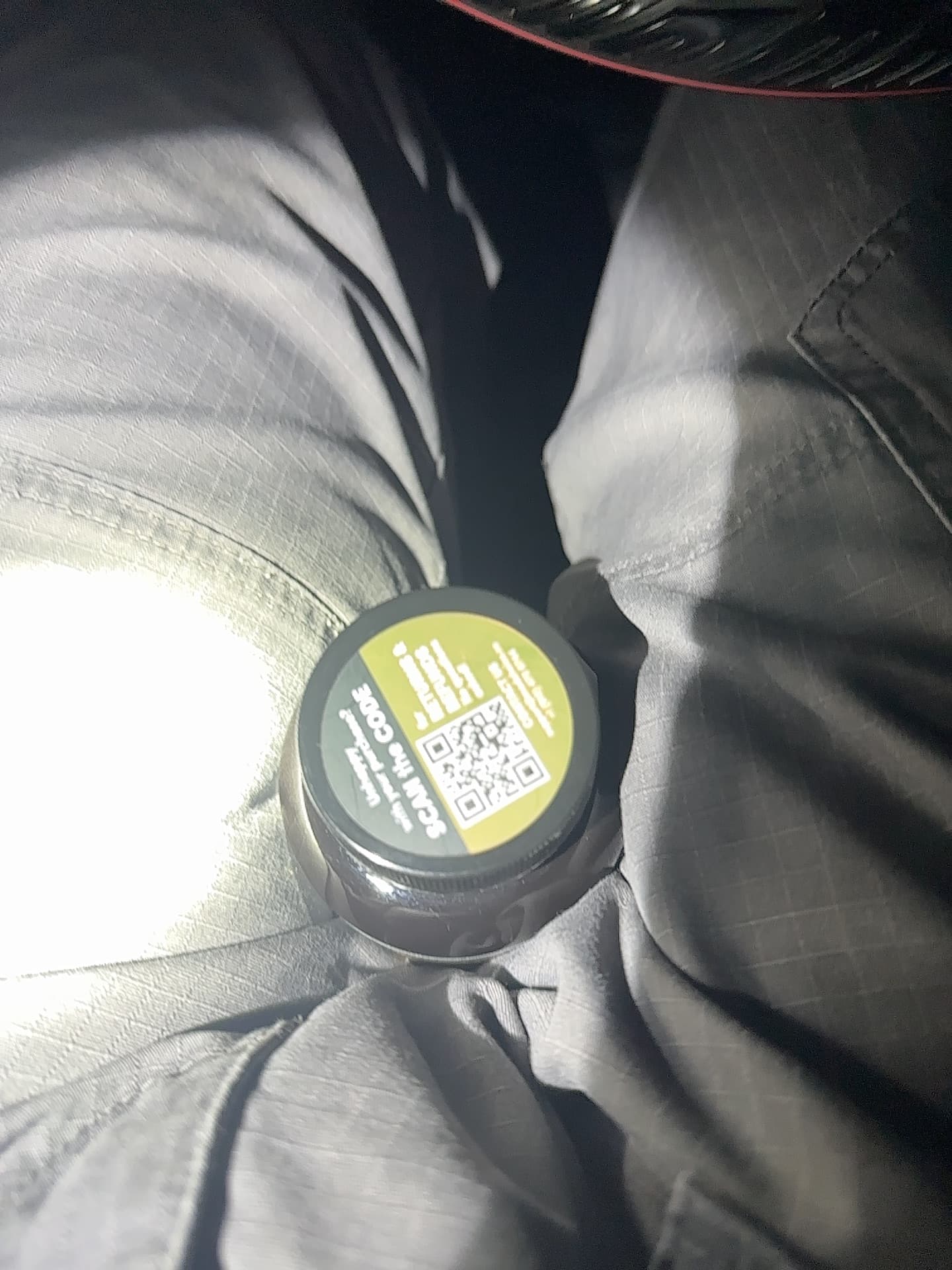 Small circular container/tin with QR code label (possibly nicotine pouches or similar product - appears to be 'Zyn' or similar brand) - AI says Real - Image 1