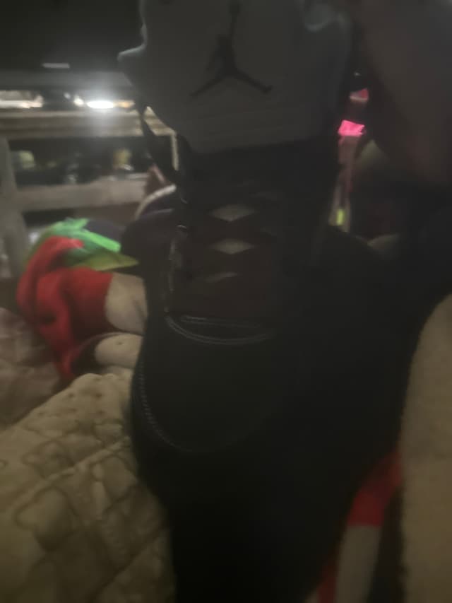 Black high-top sneaker/boot with side zipper and contrast stitching (exact brand/model not identifiable) - AI says Real