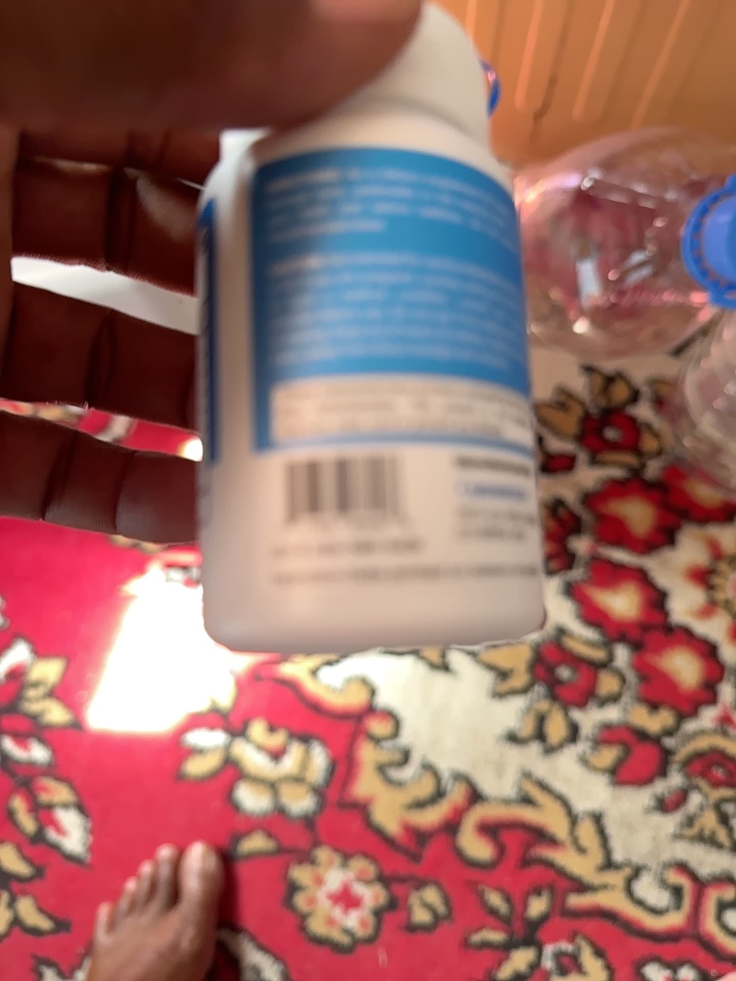 Small white bottle with blue label (likely a nasal spray, eye drops, or similar pharmaceutical/healthcare product) - AI says Real - Image 1